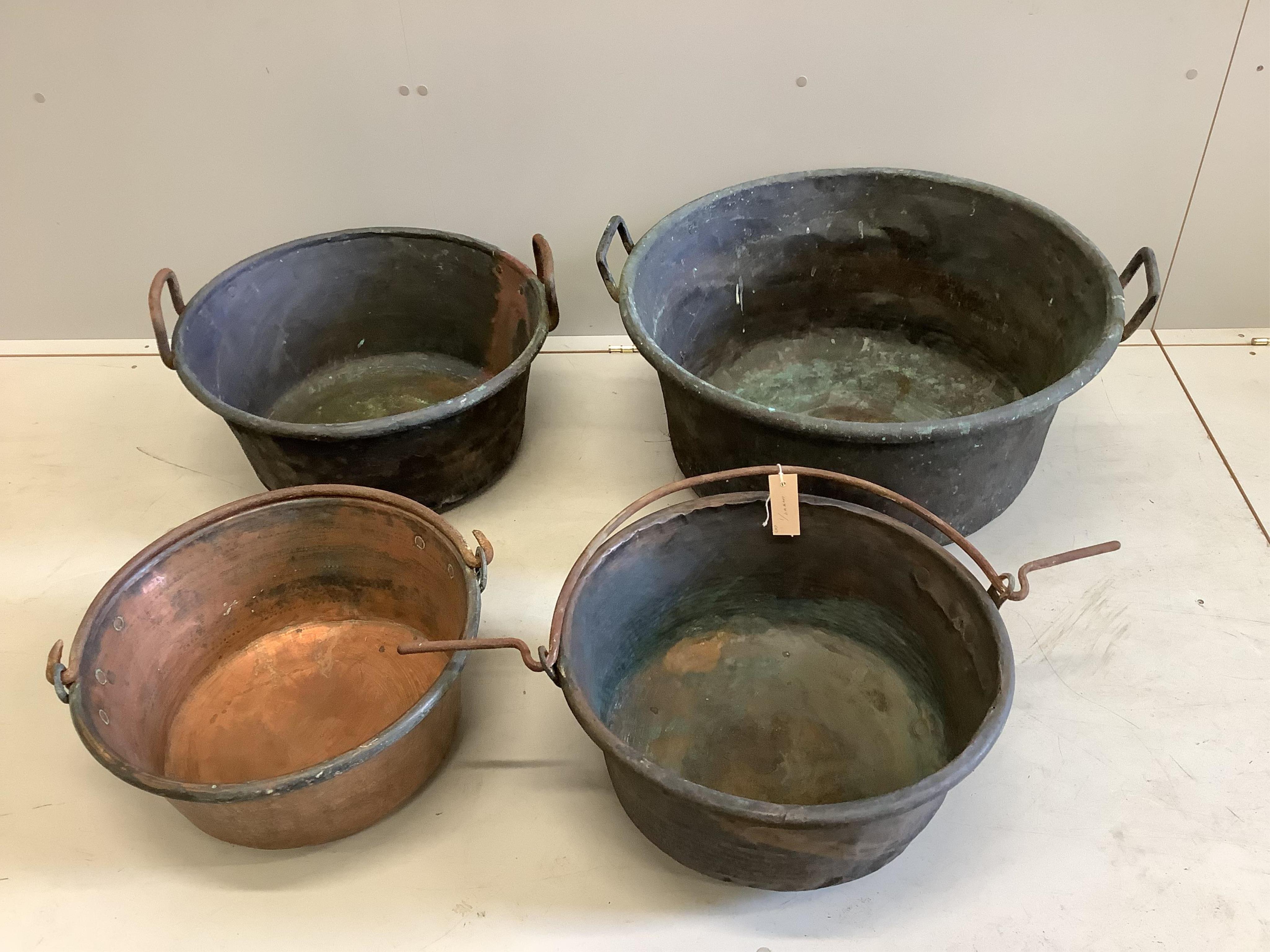 Four 19th century circular copper pans, largest diameter 66cm, height 32cm. Condition - fair